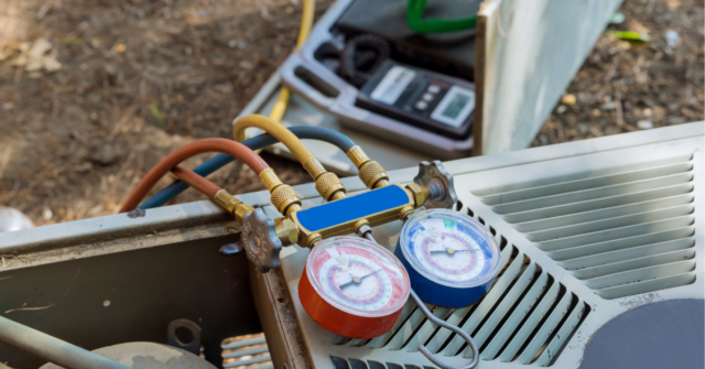 Refrigerant gauges are shown on top of an outside air conditioning unit.